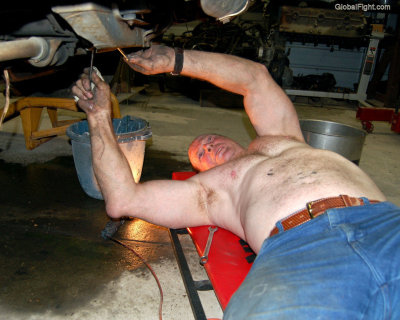 shirtless furry chest man working changing oil.jpg