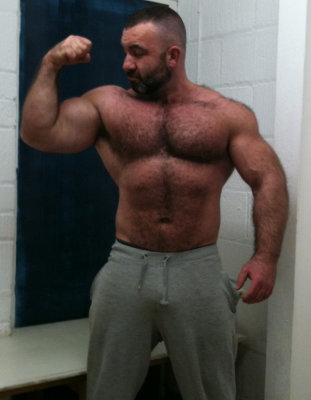 musle man flexing huge guns hairyguy.jpg