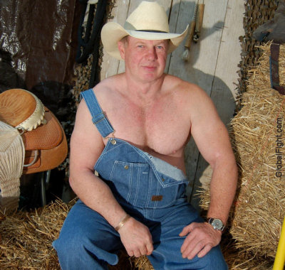 horseman sitting on hay bales horse barn.jpg
