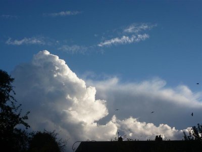 Towering clouds over neighbouring chimneys