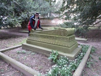 Examining an ornate gravestone