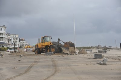 heavy equipment was brought in to clean the sand, benches and planters