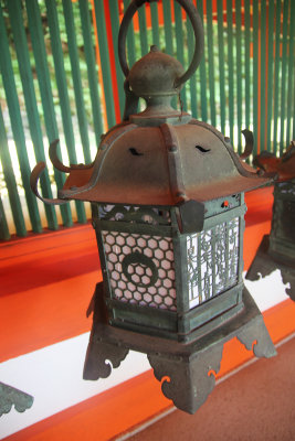 Close-up of one of a bronze lantern. All of the lanterns have different designs.