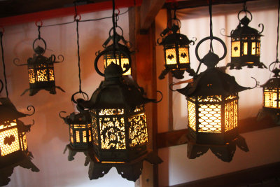 Illuminated bronze lanterns hanging at the Kasuga Grand Shrine.