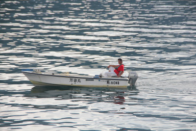 Motor boat with reflections on Lake Ashi.