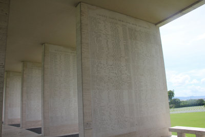 Names of the dead are listed on pillars at the cemetery.