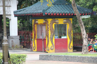 A ticket booth with dragons. Note the sign that says, Comfort Room Inside.