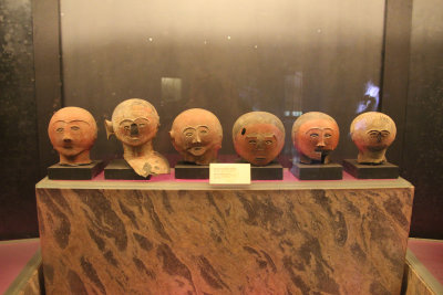Anthropomorphic jar covers from the Ayub Cave with faces that were originally painted red and black.