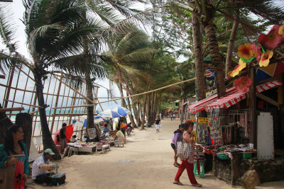 Pathway with shops and restaurants along the beach.