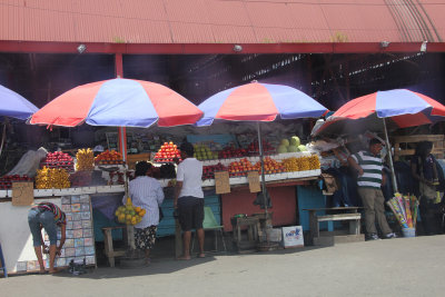 Umbrellas to protect a fruit stand from the intense Guyana sun.