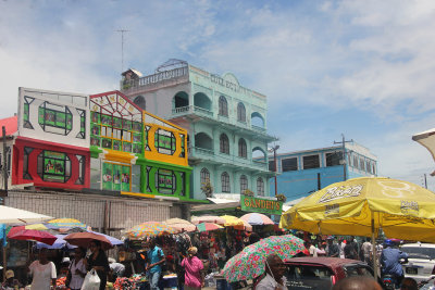 More buildings and shops and shoppers nearby the Stabroek Market.