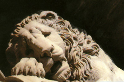 The lion is very sad.  He is dying on the shield (commemorating the last stand of soldiers during the French Revolution).