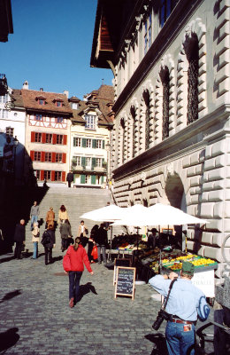 Fruit vendors set up beneath the old city steps.