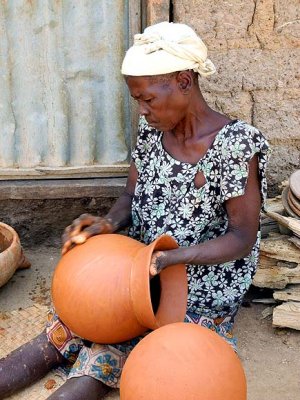 Handmade pots are decorated with colour and simple patterns made with corncobs. Pottery village Sitiana, Burkina Faso