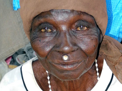 Lobi woman wearing the traditional small wooden disc above her upper lip, Burkina Faso