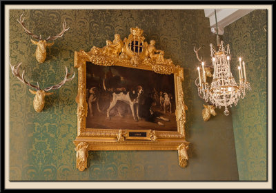 l'bat, in an ornate frame.