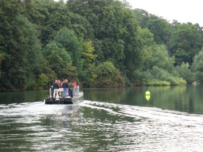 The outboard powered dry rubbish boat sets off