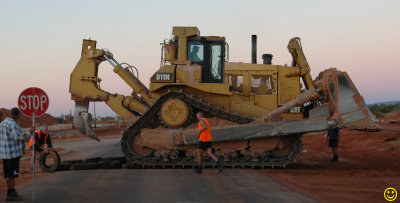 Why did the bulldozer cross the road?