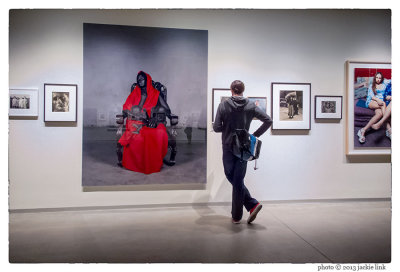 Pier 24-man contemplating V. Beecroft's Black Madonna with Twins