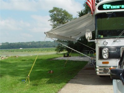 BUDDY RELAXES IN THE SHADE AS A YACHT PASSES BY ON THE MISSISSIPPI RIVER