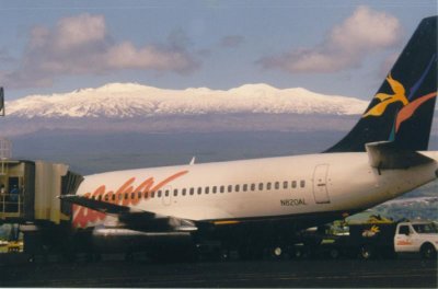 A/C 820 at Hilo Airport with Snow capped MaunaKea