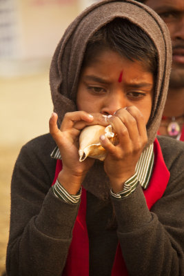 Boy blowing shell.jpg