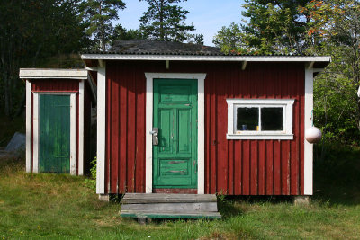 Small red houses with green doors