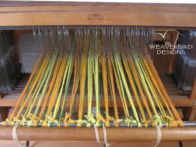 Threaded and tied onto back apron rod