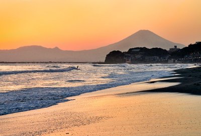 Surfer at Kamakura with Mount Fuji in the background