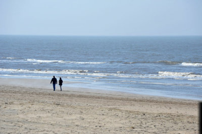 A couple strolling along the beach at Noordwijk mid-April