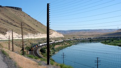 Union Pacific freight train and rock fence along the Snake River