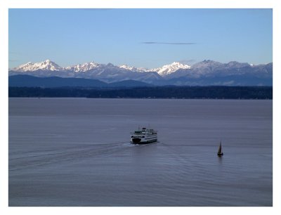 The Sun's First Rays Hit the Olympic Mountains as the Ferry Heads Out