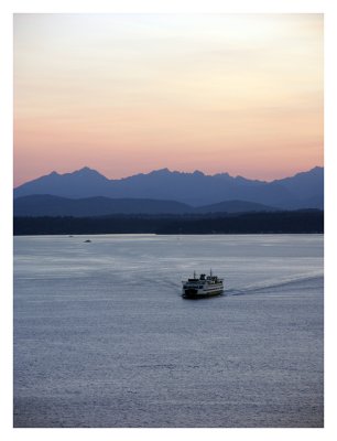 Ferry Approaches Seattle Against the Backdrop of the Olympic Mountains