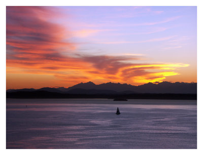 Sailboat Enjoys a Sunset Over Elliot Bay and the Olympic Mountains