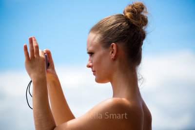 Young woman on ferry taking photographs of the Harbour