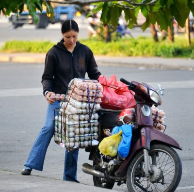 egg delivery via scooter, Nguyen Huu Tho Street, District 7, Saigon, Vietnam  
