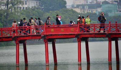 tourists on The Huc Bridge, Hoan Kiem Lake, Hanoi, Vietnam  