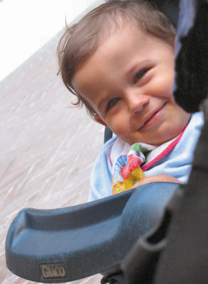 At next table in cafe, a mischievous boy