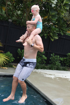 Cam and Mila jumping in the pool