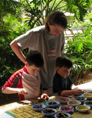 Mom helping Dennis & Duncan paint t-shirts