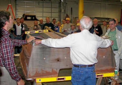 Master woodworker, FRANK BECHT, left, explains what's involved in replacing stringers, ribs, etc.