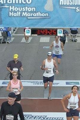 Greg crossing the finish line at Houston Half