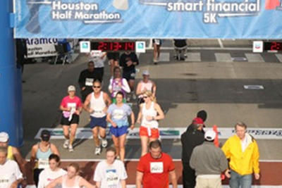 JoLee crossing the finish line at Houston Half