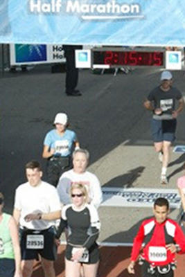 Susie crossing the finish line at Houston Half