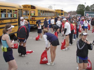 Putting bags on baggage buses before start of marathon