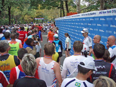 Runners being photographed in front of the official wall