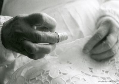 Old hands embroidering