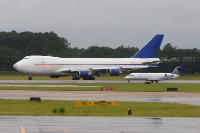 Two waiting their turn to Depart Houston in the rain.