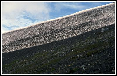 Snow drift on Antillanca Volcano black ash (late summer).