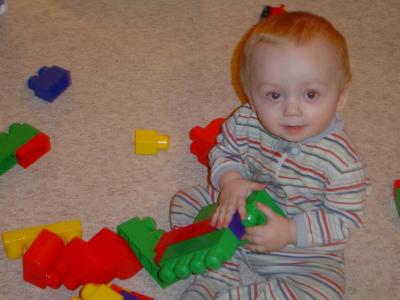 Whats more red, his hair or the blocks?